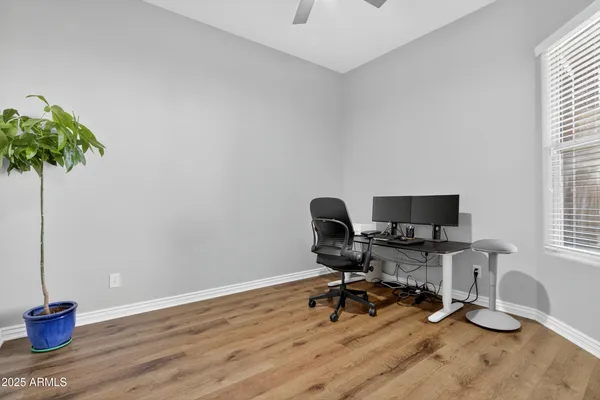 a view of a workspace with furniture and a window