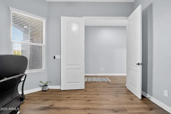 a view of workspace with wooden floor and windows