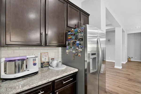 a kitchen with stainless steel appliances granite countertop a refrigerator and a stove