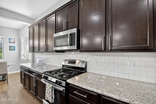 a kitchen with granite countertop stainless steel appliances and cabinets