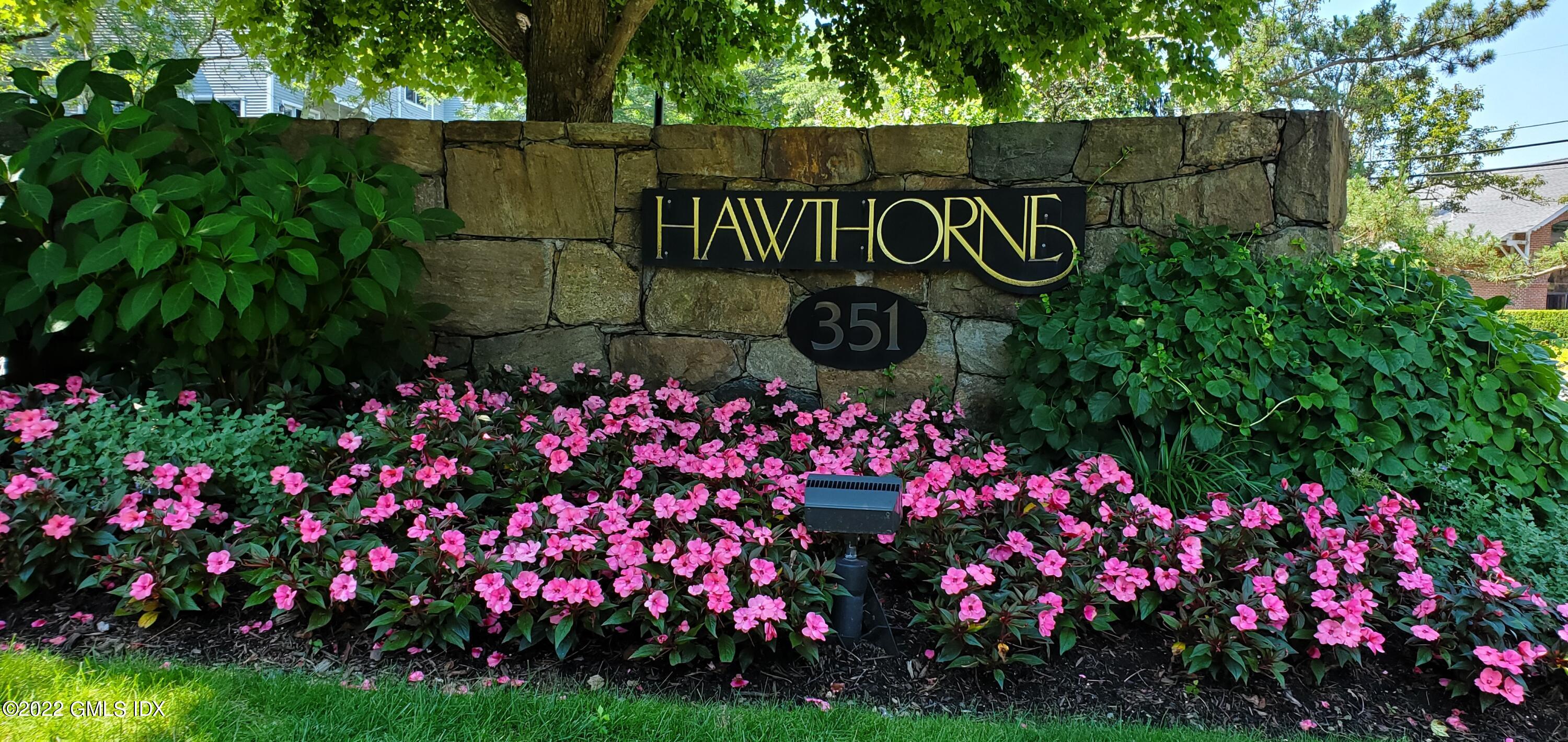 351 Pemberwick Road, Unit 821 Greenwich, CT 06831 - Photo 1 of 16 a street sign that is in front of flowers