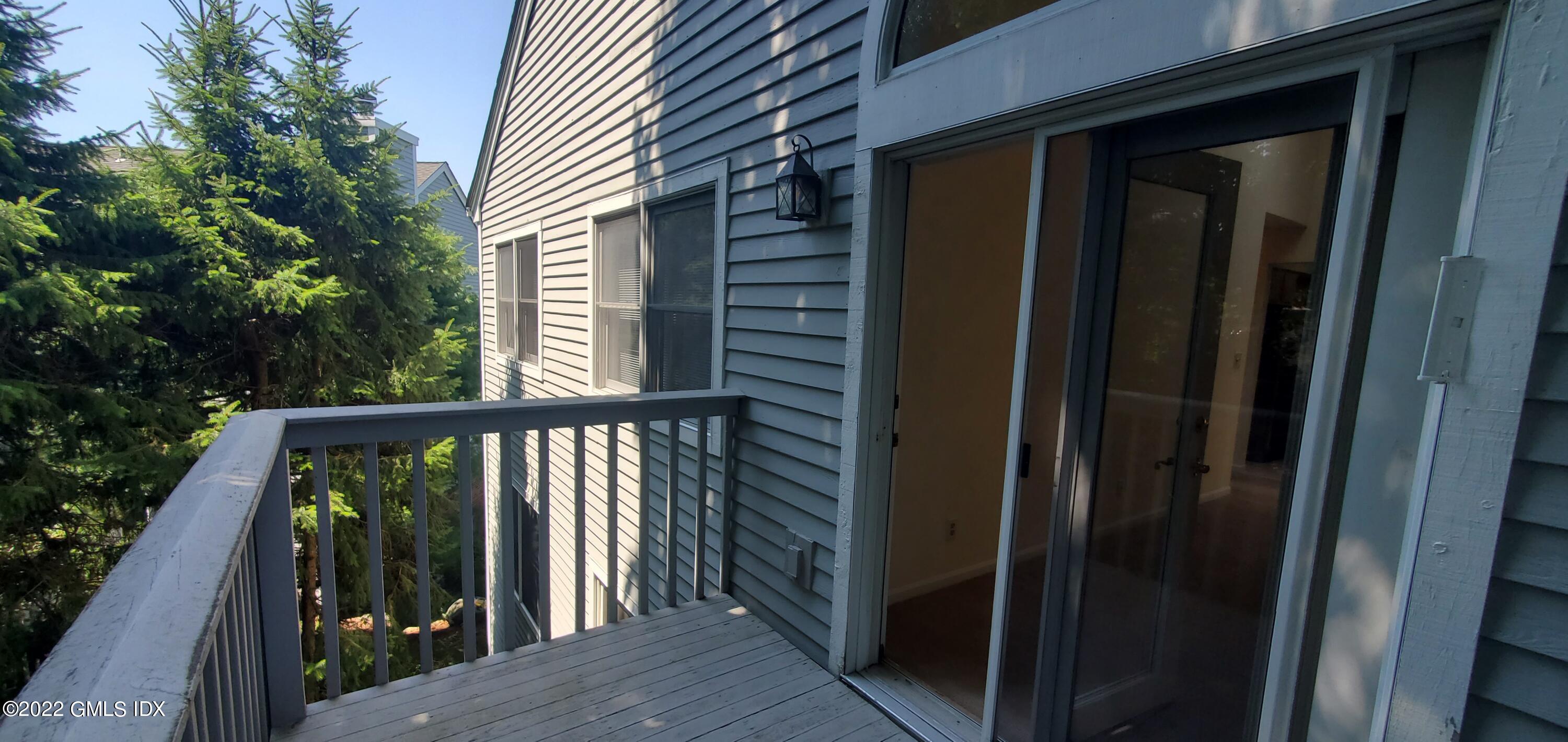 351 Pemberwick Road, Unit 821 Greenwich, CT 06831 - Photo 12 of 16 a view of a balcony with wooden floor
