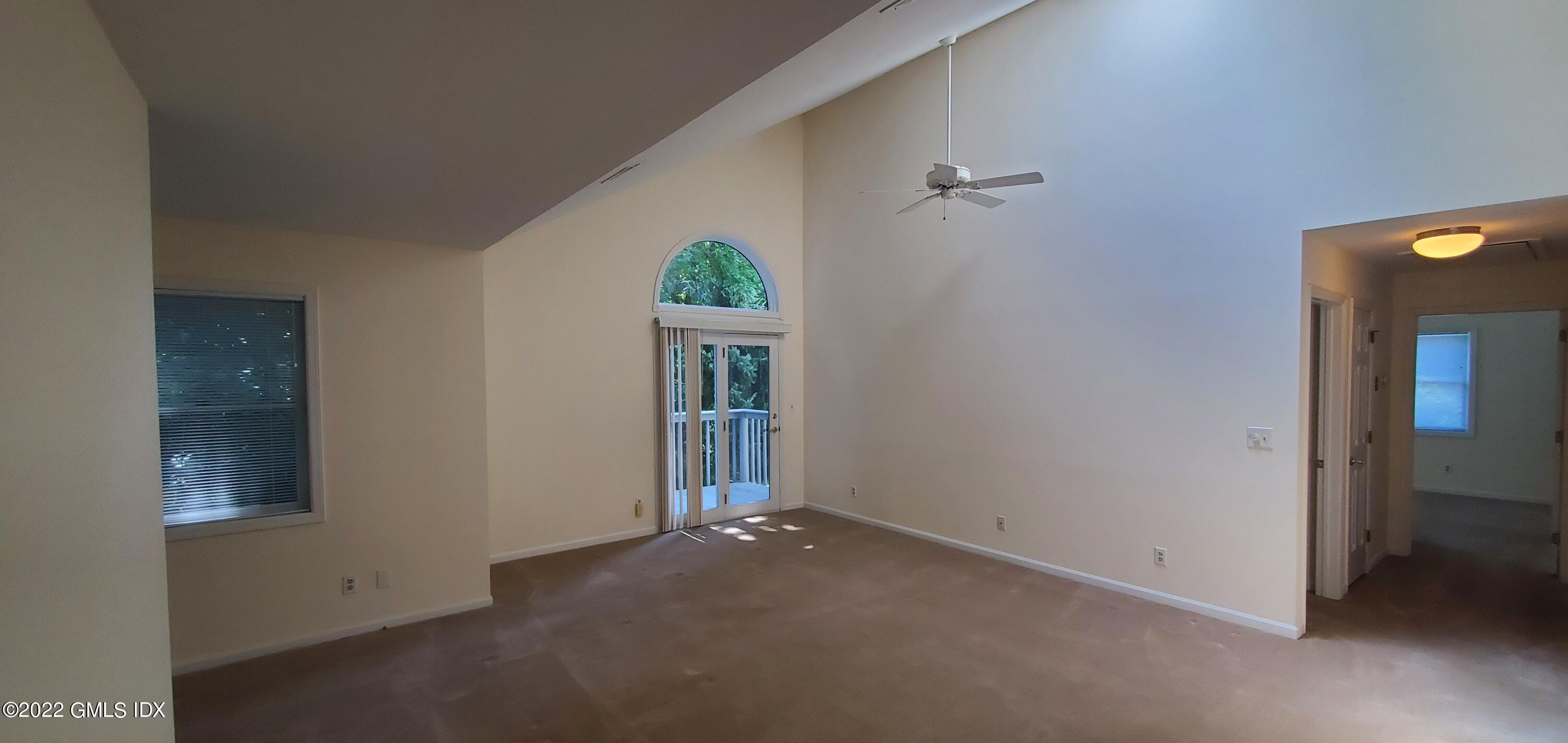 351 Pemberwick Road, Unit 821 Greenwich, CT 06831 - Photo 3 of 16 an empty room with windows