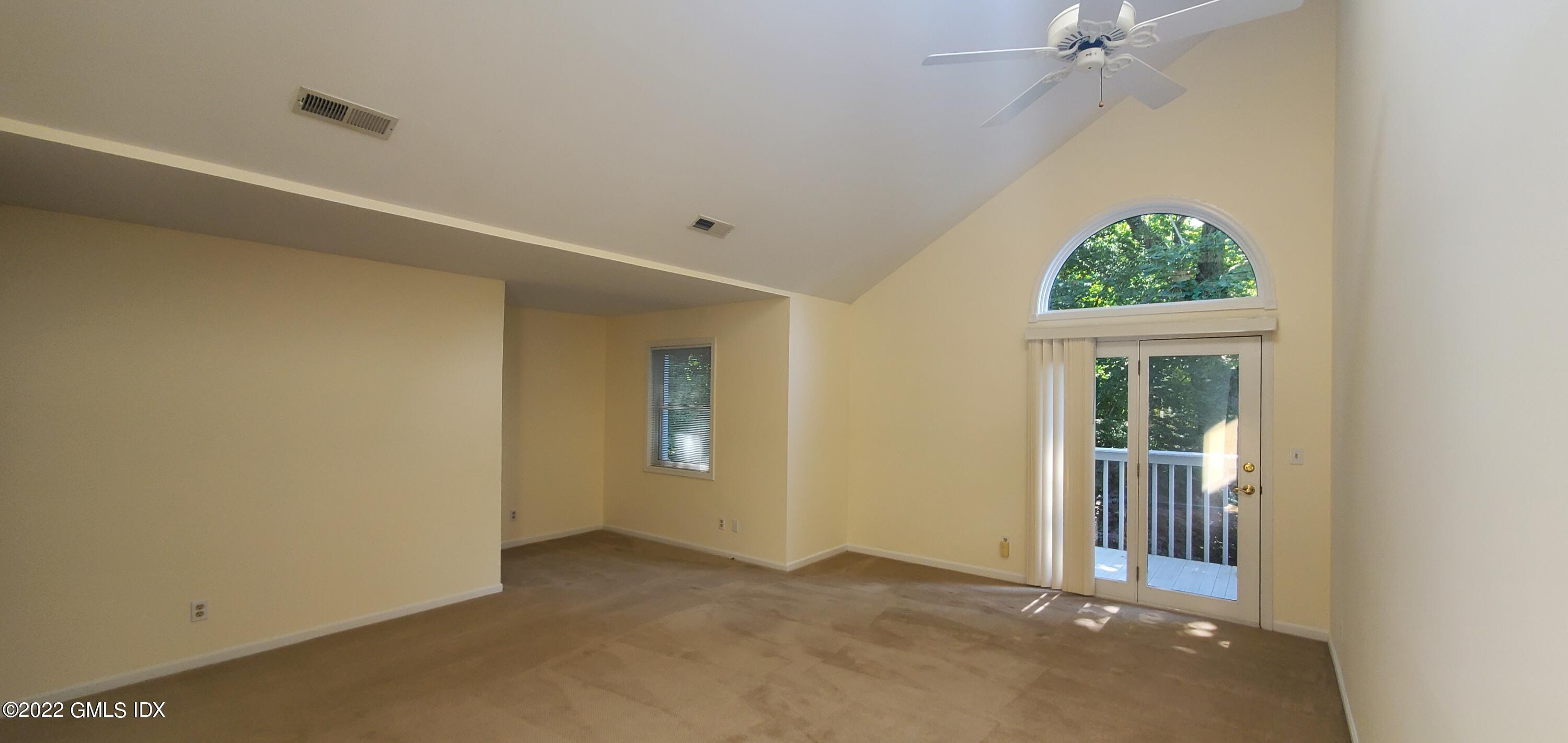 351 Pemberwick Road, Unit 821 Greenwich, CT 06831 - Photo 4 of 16 an empty room with a window and a ceiling fan