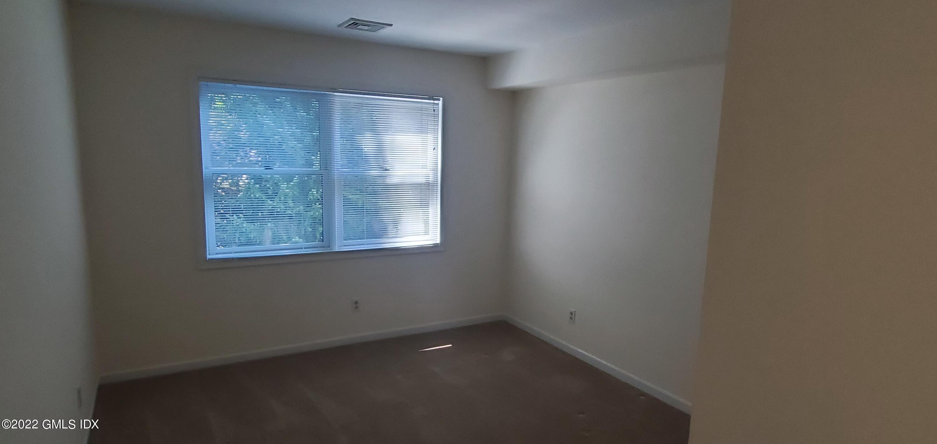 351 Pemberwick Road, Unit 821 Greenwich, CT 06831 - Photo 10 of 16 an empty room with a window