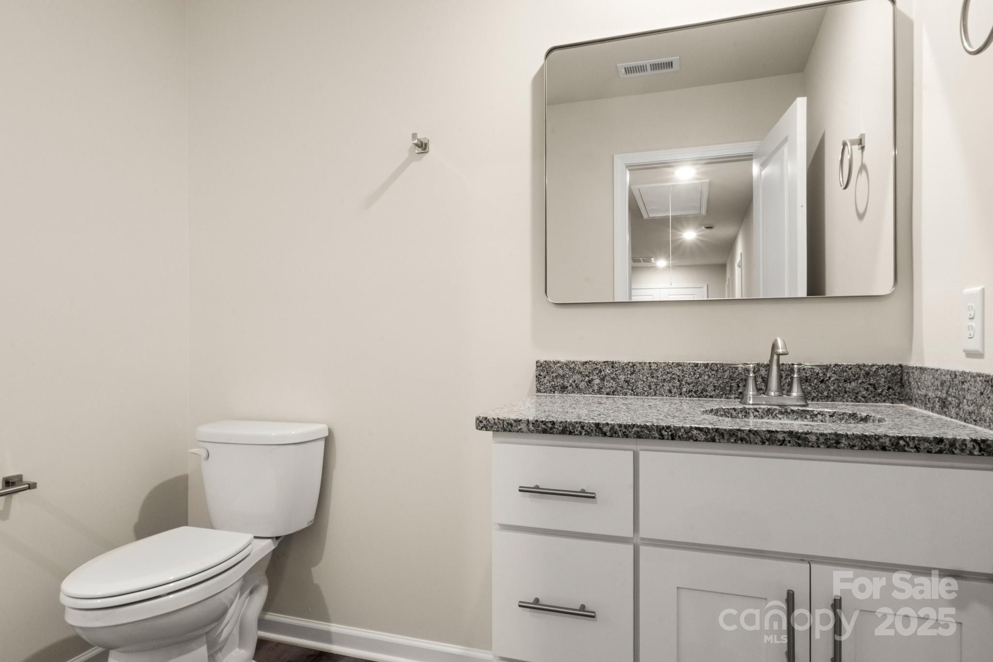 990 Shearers Road Mooresville, NC 28115 - Photo 18 of 46 a bathroom with a toilet sink and mirror