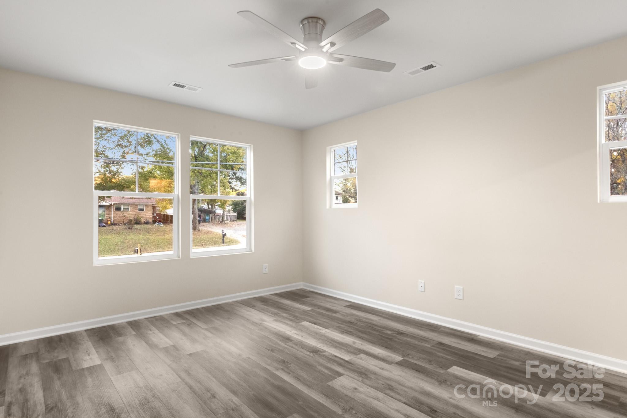 990 Shearers Road Mooresville, NC 28115 - Photo 32 of 46 a view of empty room with wooden floor and fan