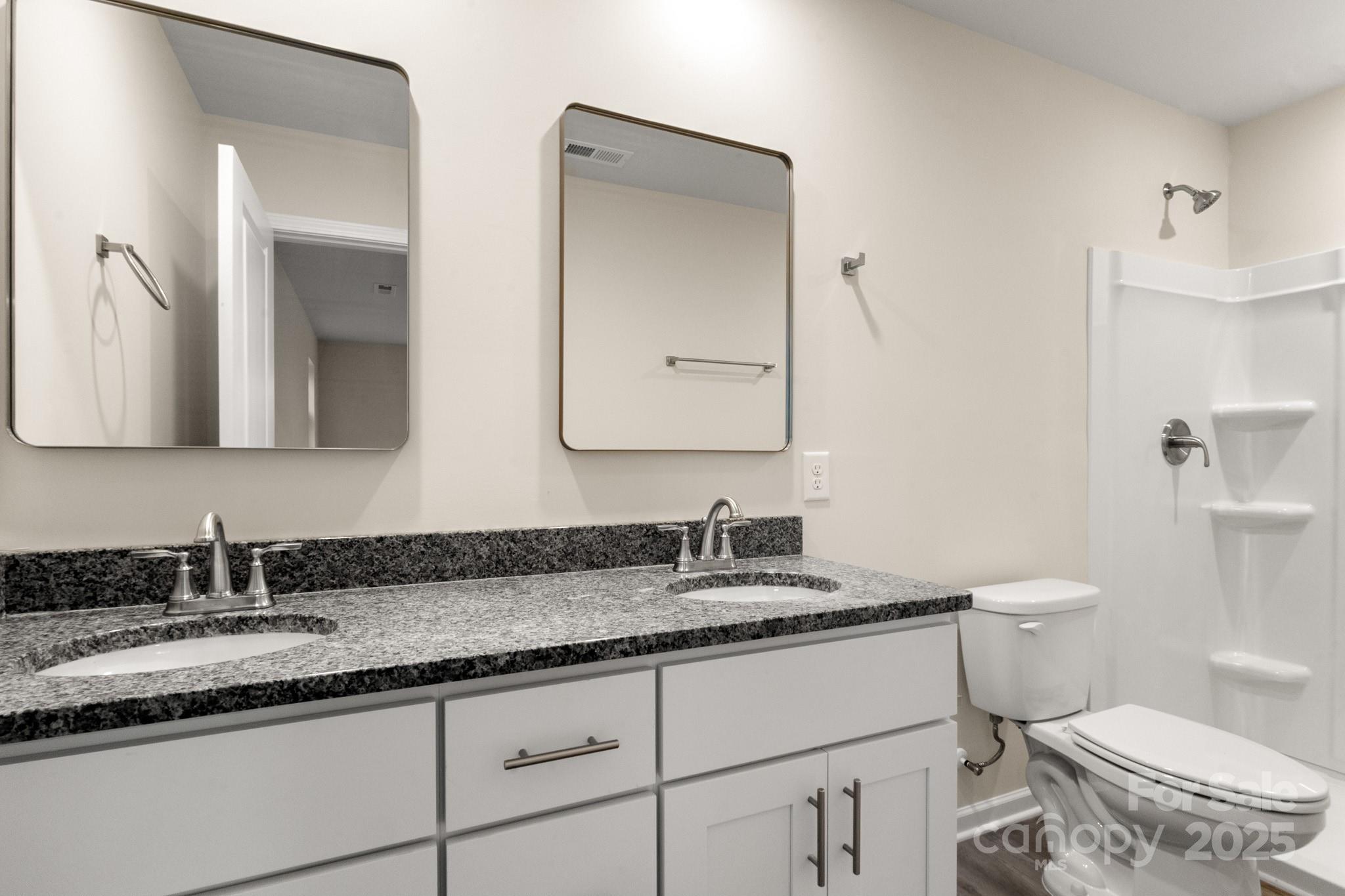 990 Shearers Road Mooresville, NC 28115 - Photo 34 of 46 a bathroom with a granite countertop toilet sink and mirror