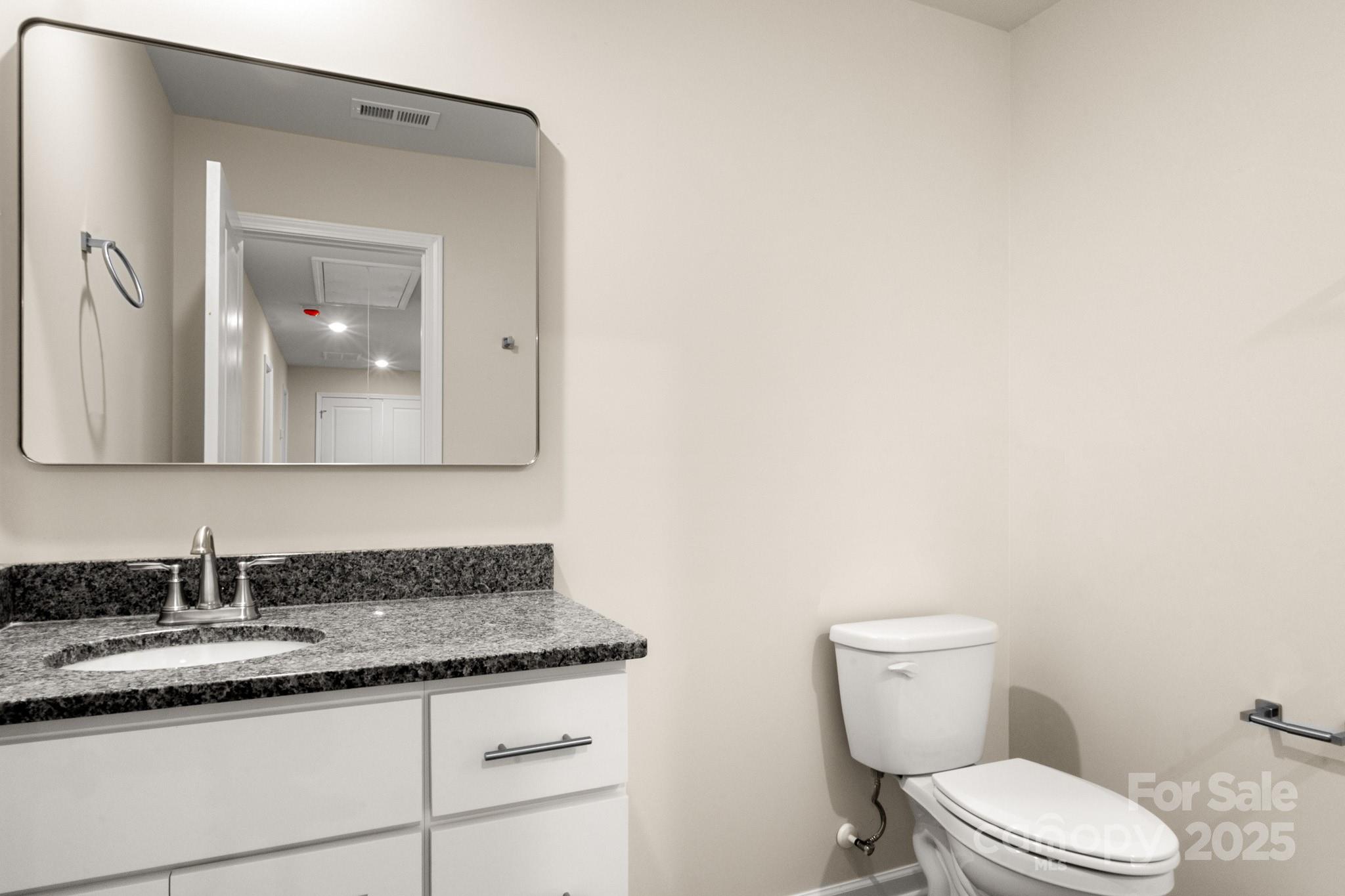 990 Shearers Road Mooresville, NC 28115 - Photo 39 of 46 a bathroom with a granite countertop toilet sink and mirror