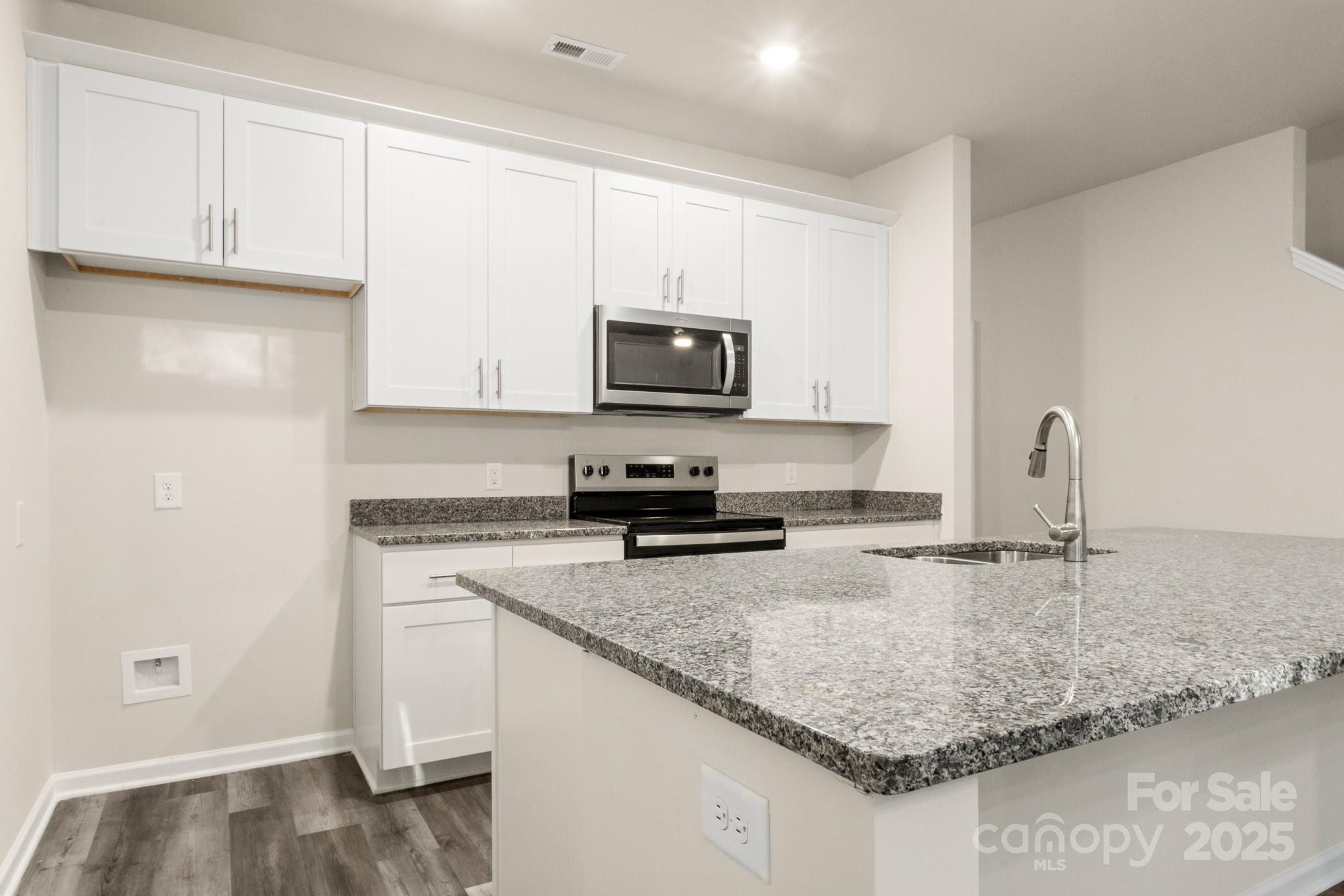 990 Shearers Road Mooresville, NC 28115 - Photo 5 of 46 a kitchen with granite countertop a sink stove and cabinets
