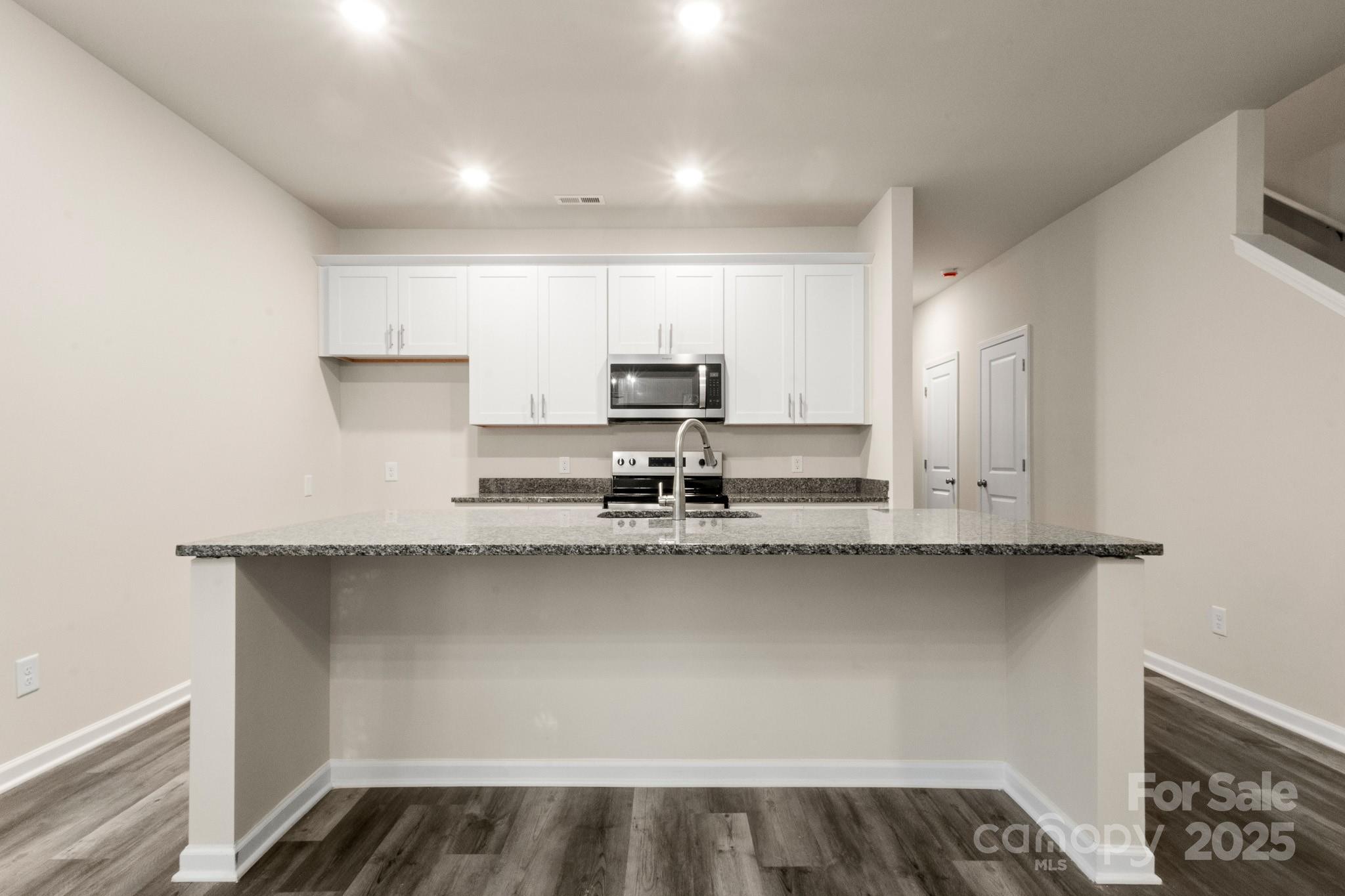 990 Shearers Road Mooresville, NC 28115 - Photo 10 of 46 a kitchen with stainless steel appliances granite countertop a sink and cabinets