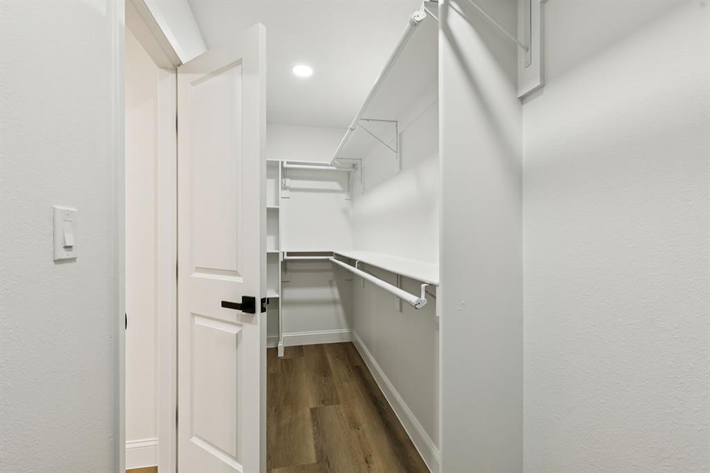 311 High Brook Drive Richardson, TX 75080 - Photo 19 of 26 Walk in closet with dark wood-style flooring