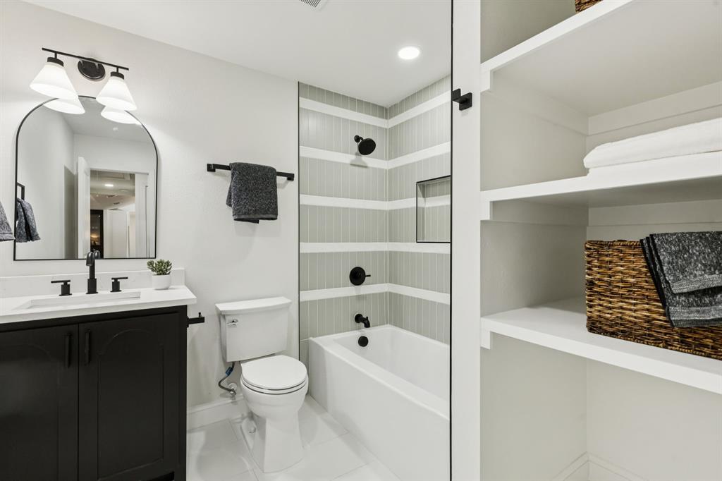 311 High Brook Drive Richardson, TX 75080 - Photo 21 of 26 Bathroom featuring tub / shower combination, vanity, and tile patterned floors