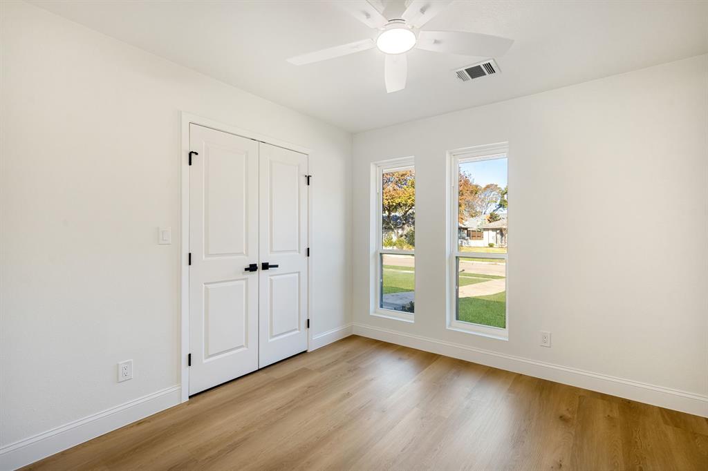 311 High Brook Drive Richardson, TX 75080 - Photo 22 of 26 Unfurnished bedroom with ceiling fan, light wood finished floors, and a closet