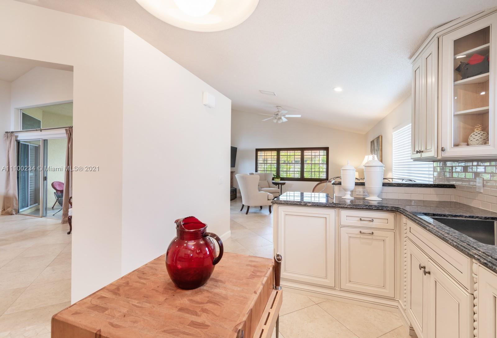 207 Cameron Court Weston, FL 33326 - Photo 12 of 35 a kitchen with stainless steel appliances granite countertop a sink and cabinets