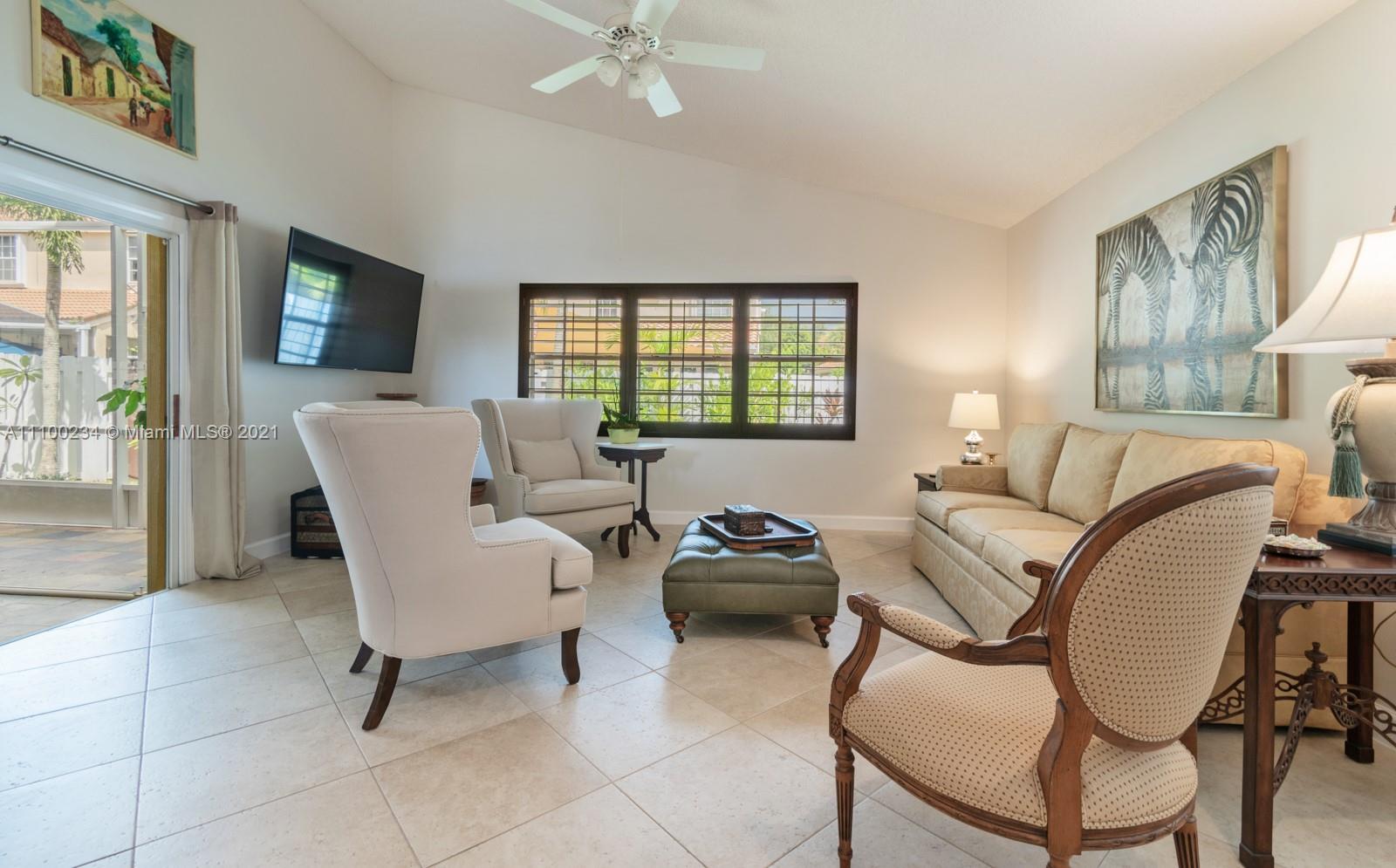 207 Cameron Court Weston, FL 33326 - Photo 13 of 35 a living room with furniture a flat screen tv and a window