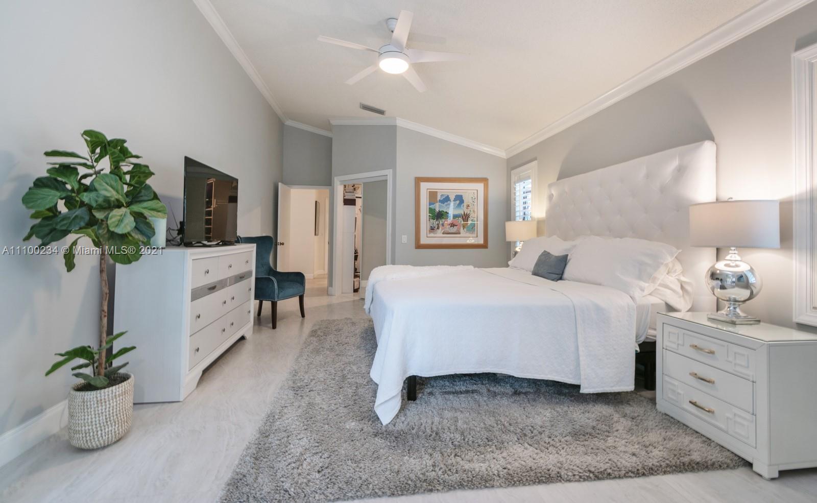 207 Cameron Court Weston, FL 33326 - Photo 16 of 35 a bedroom with a bed and a potted plant