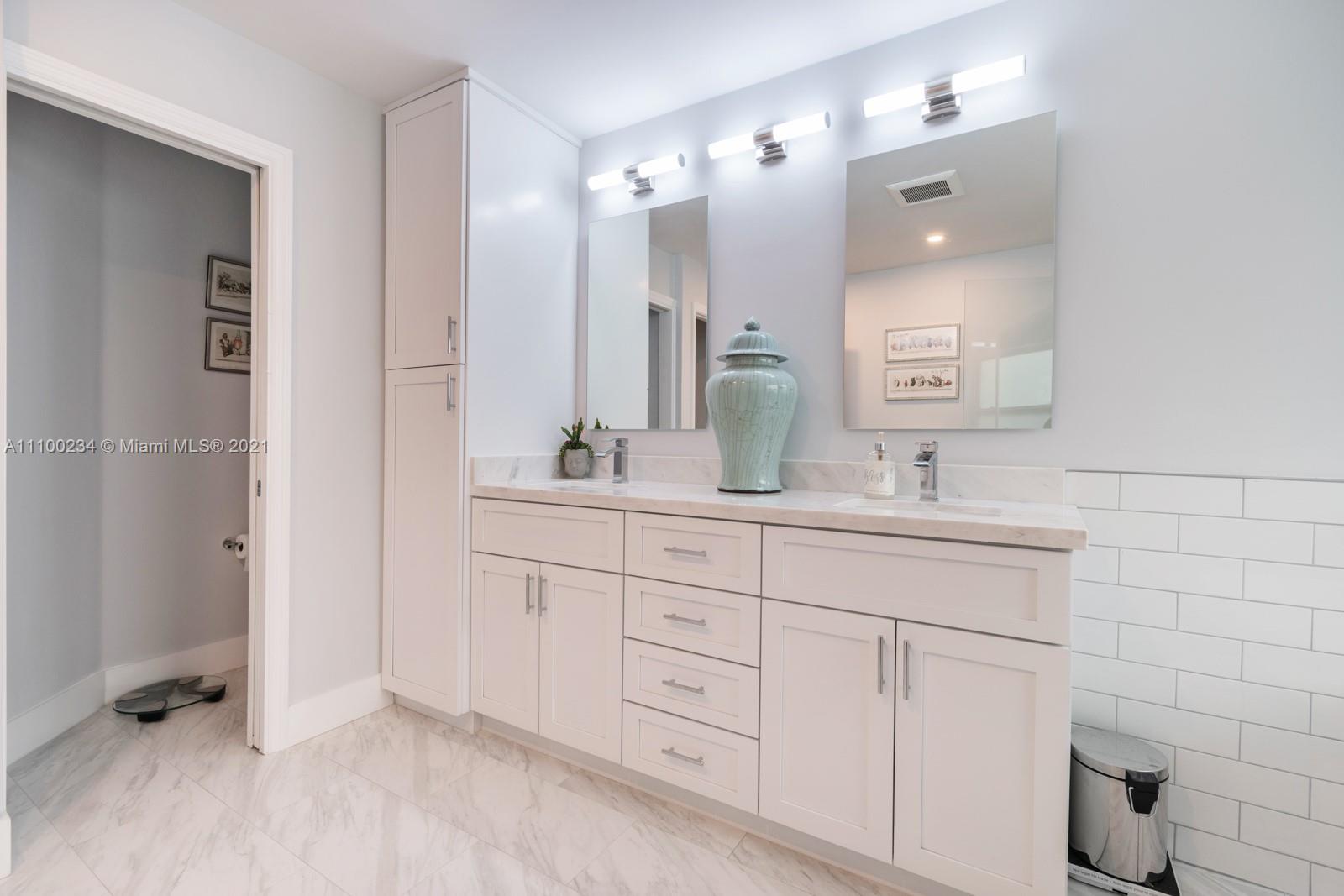 207 Cameron Court Weston, FL 33326 - Photo 18 of 35 a bathroom with a double vanity sink a mirror and a shower