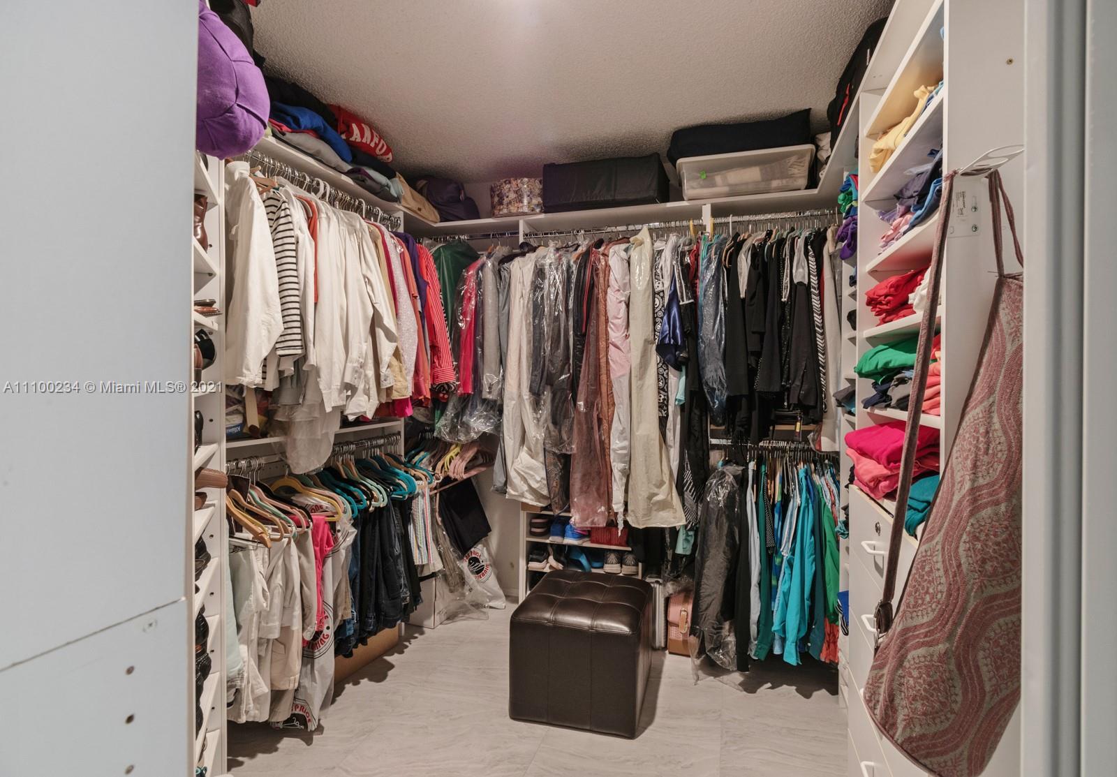 207 Cameron Court Weston, FL 33326 - Photo 19 of 35 a view of walk in closet with clothes