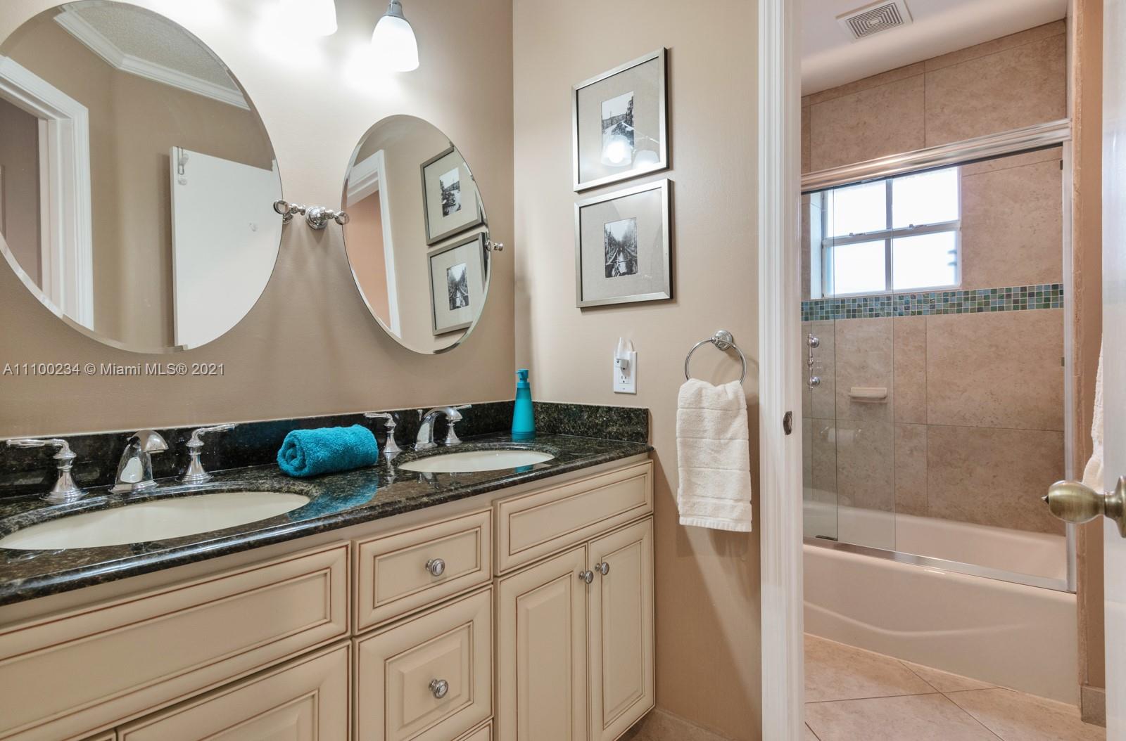 207 Cameron Court Weston, FL 33326 - Photo 23 of 35 a bathroom with a granite countertop sink a mirror a vanity and shower