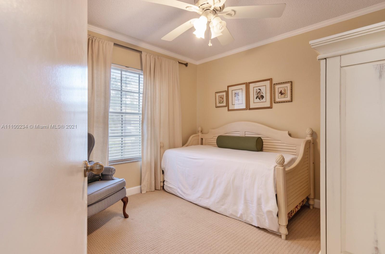 207 Cameron Court Weston, FL 33326 - Photo 24 of 35 a bedroom with a bed and a chandelier