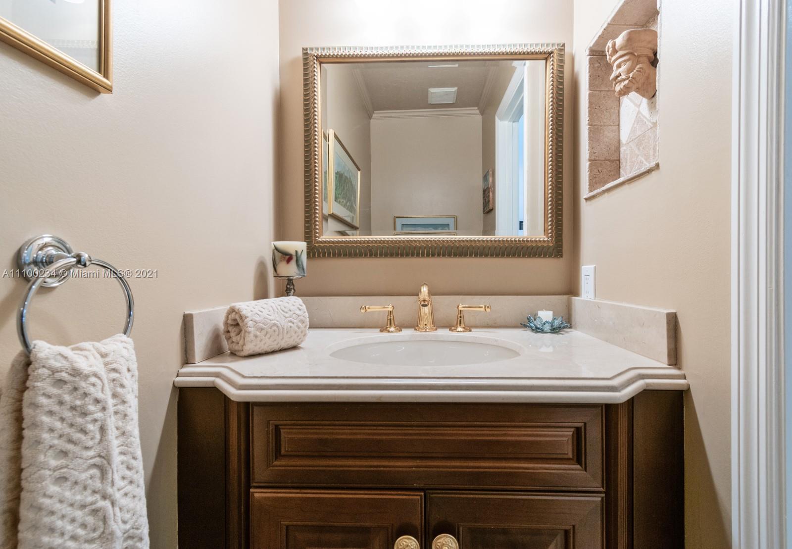 207 Cameron Court Weston, FL 33326 - Photo 27 of 35 a bathroom with a sink vanity and a mirror