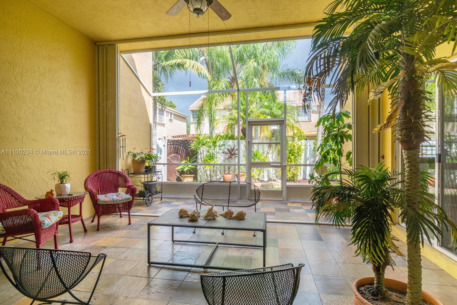 207 Cameron Court Weston, FL 33326 - Photo 30 of 35 a living room with furniture and a large window
