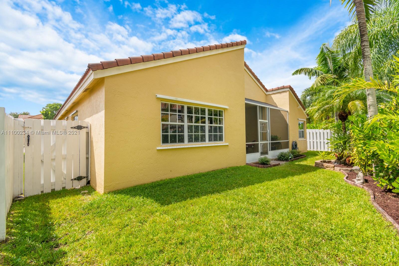 207 Cameron Court Weston, FL 33326 - Photo 33 of 35 a view of a backyard with plants and large tree