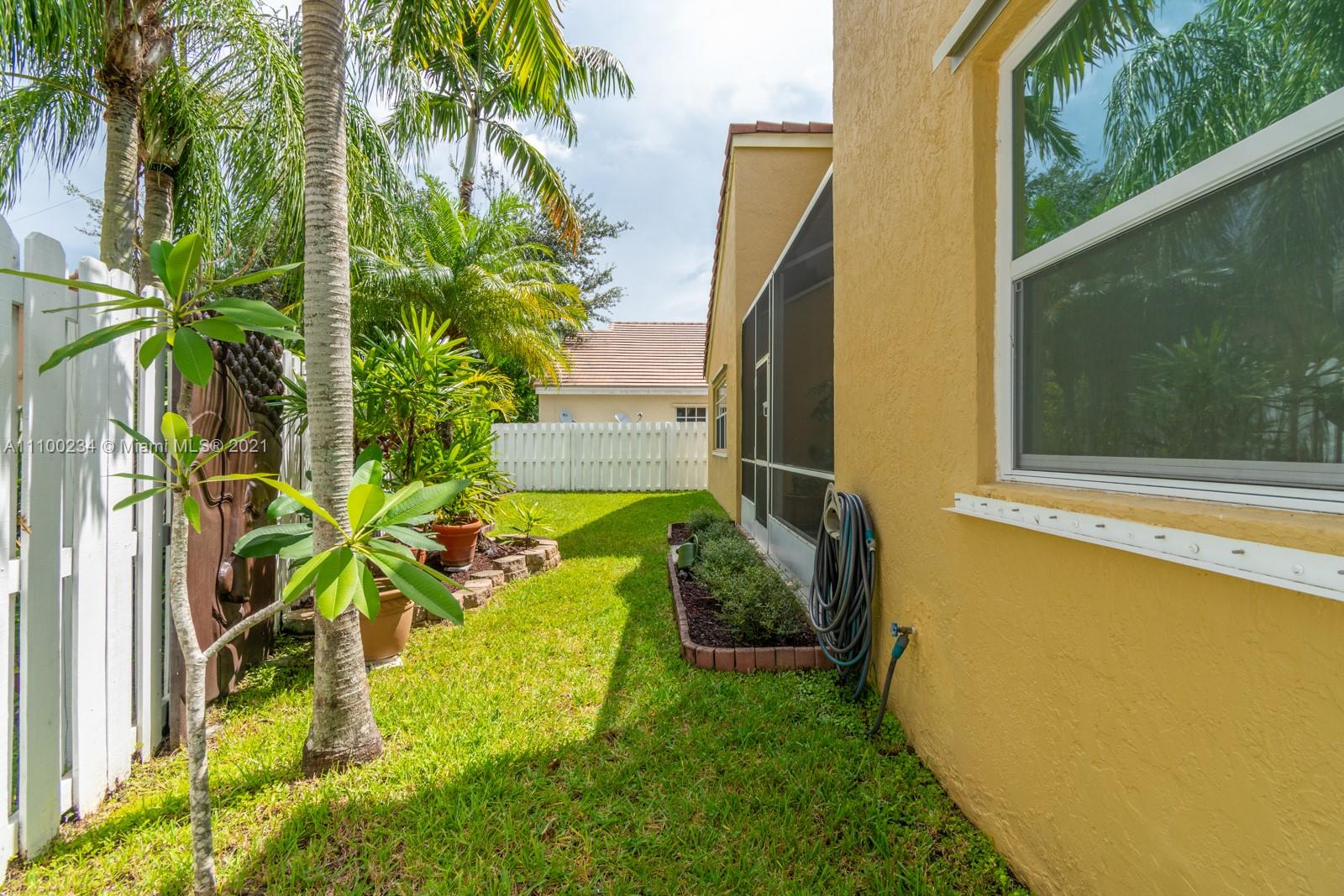 207 Cameron Court Weston, FL 33326 - Photo 35 of 35 a yellow plant sitting in front of a window