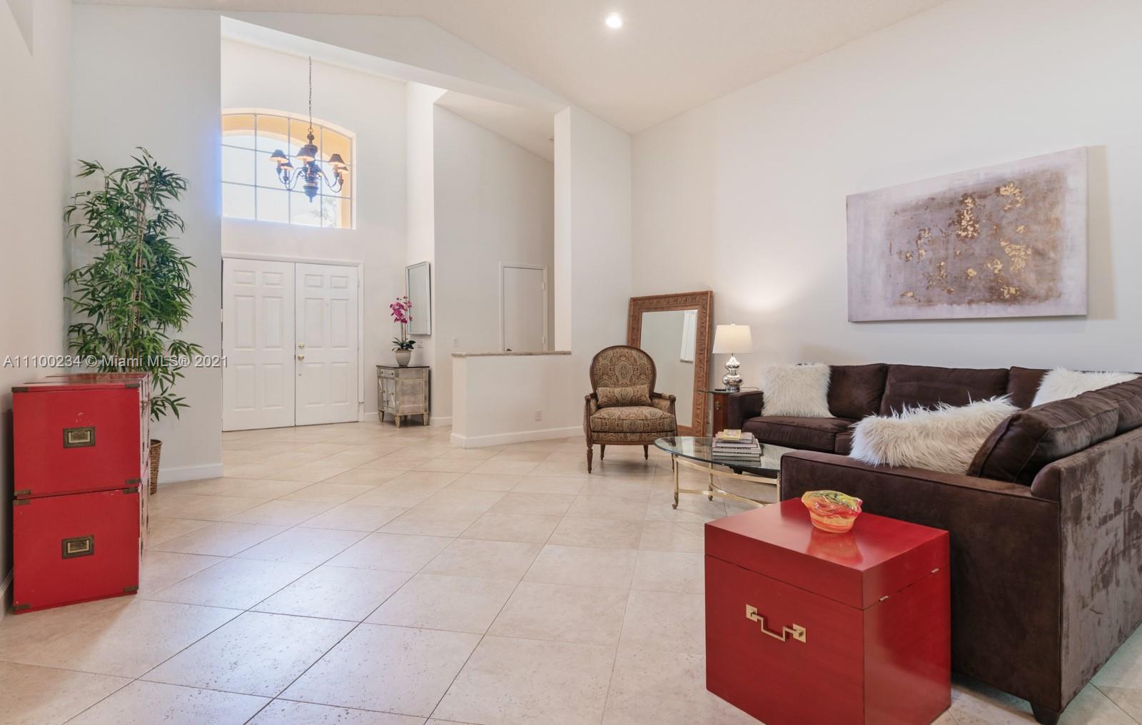 207 Cameron Court Weston, FL 33326 - Photo 8 of 35 a living room with furniture and a lamp