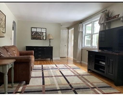 152 Haynes Road Sudbury, MA 01776 - Photo 4 of 25 a living room with furniture a flat screen tv and a fireplace