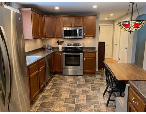 152 Haynes Road Sudbury, MA 01776 - Photo 6 of 25 a kitchen with stainless steel appliances a stove a sink a microwave a refrigerator and cabinets