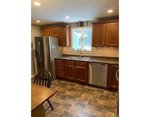 152 Haynes Road Sudbury, MA 01776 - Photo 7 of 25 a kitchen with stainless steel appliances granite countertop a sink and a refrigerator