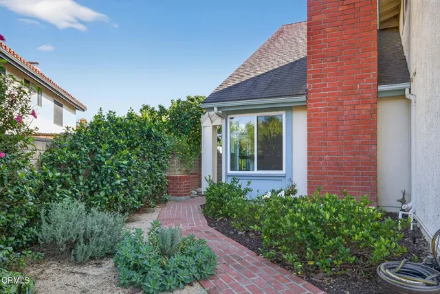 a view of a house with potted plants