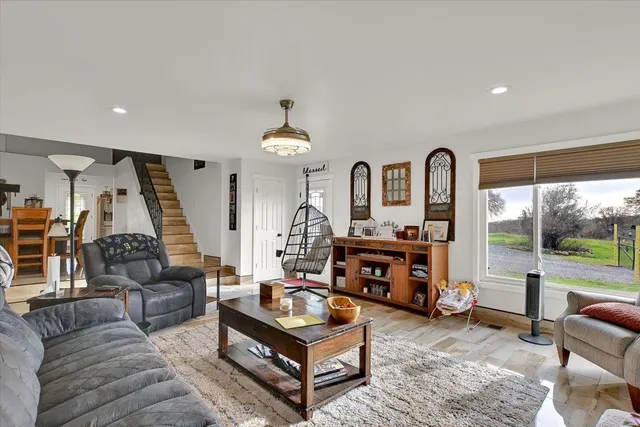 a living room with furniture and a floor to ceiling window