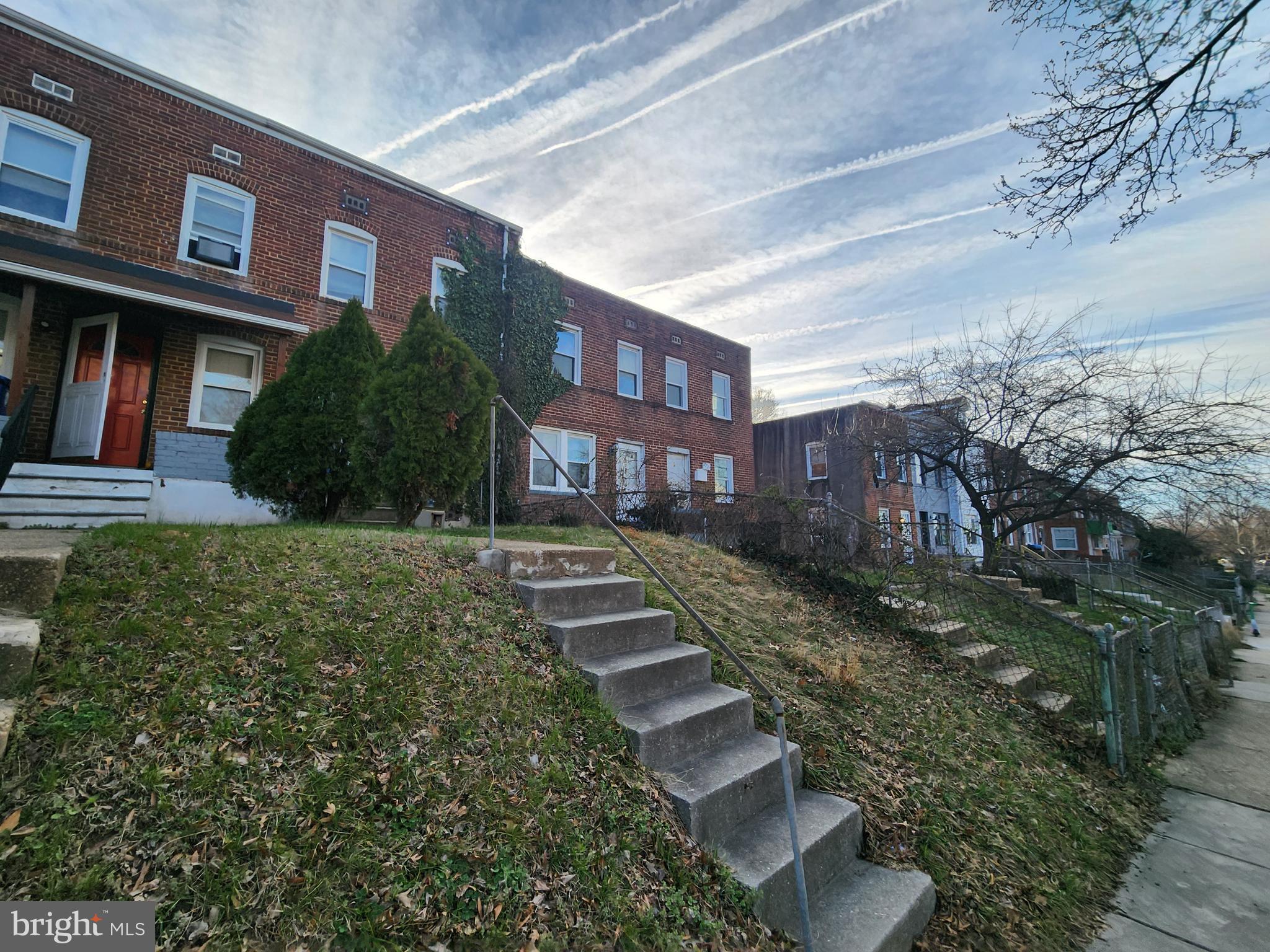 2723 Round Road Baltimore, MD 21225 - Photo 4 of 18 a view of a brick building next to a yard