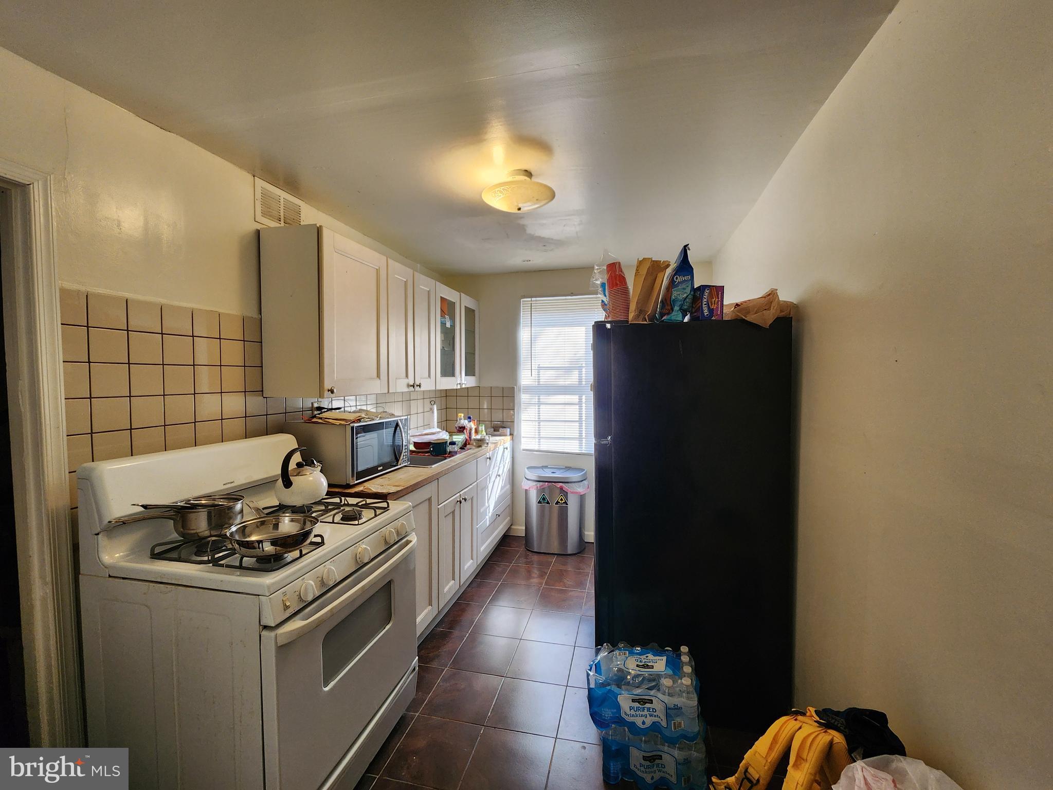 2723 Round Road Baltimore, MD 21225 - Photo 8 of 18 a kitchen with a stove and a refrigerator