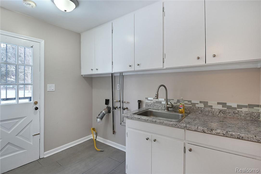 1194 Rocky Ridge Trail Flint, MI 48532 - Photo 23 of 41 Laundry Room with entry from backyard and also from garage. Connected via doorway to basement and to kitchen