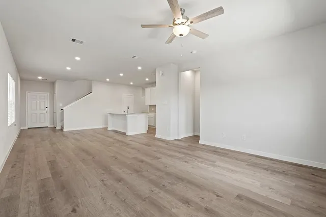 a view of an empty room with a ceiling fan