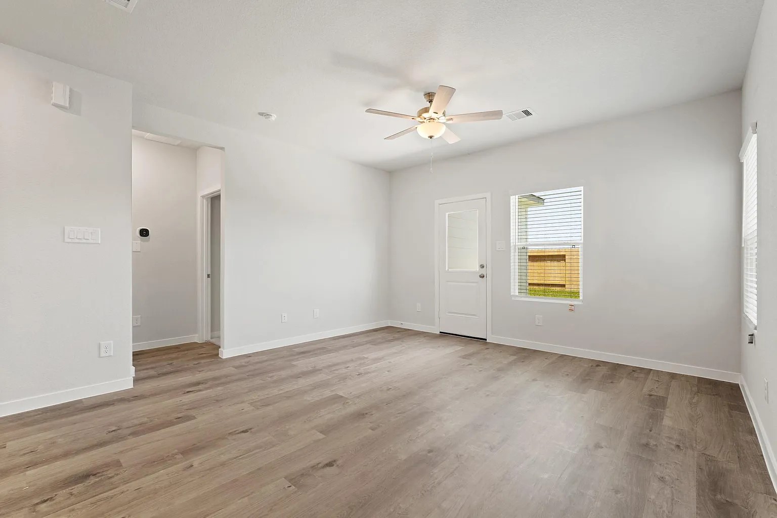 3927 Accolade Crossing Brookshire, TX 77423 - Photo 6 of 21 an empty room with a window and wooden floor