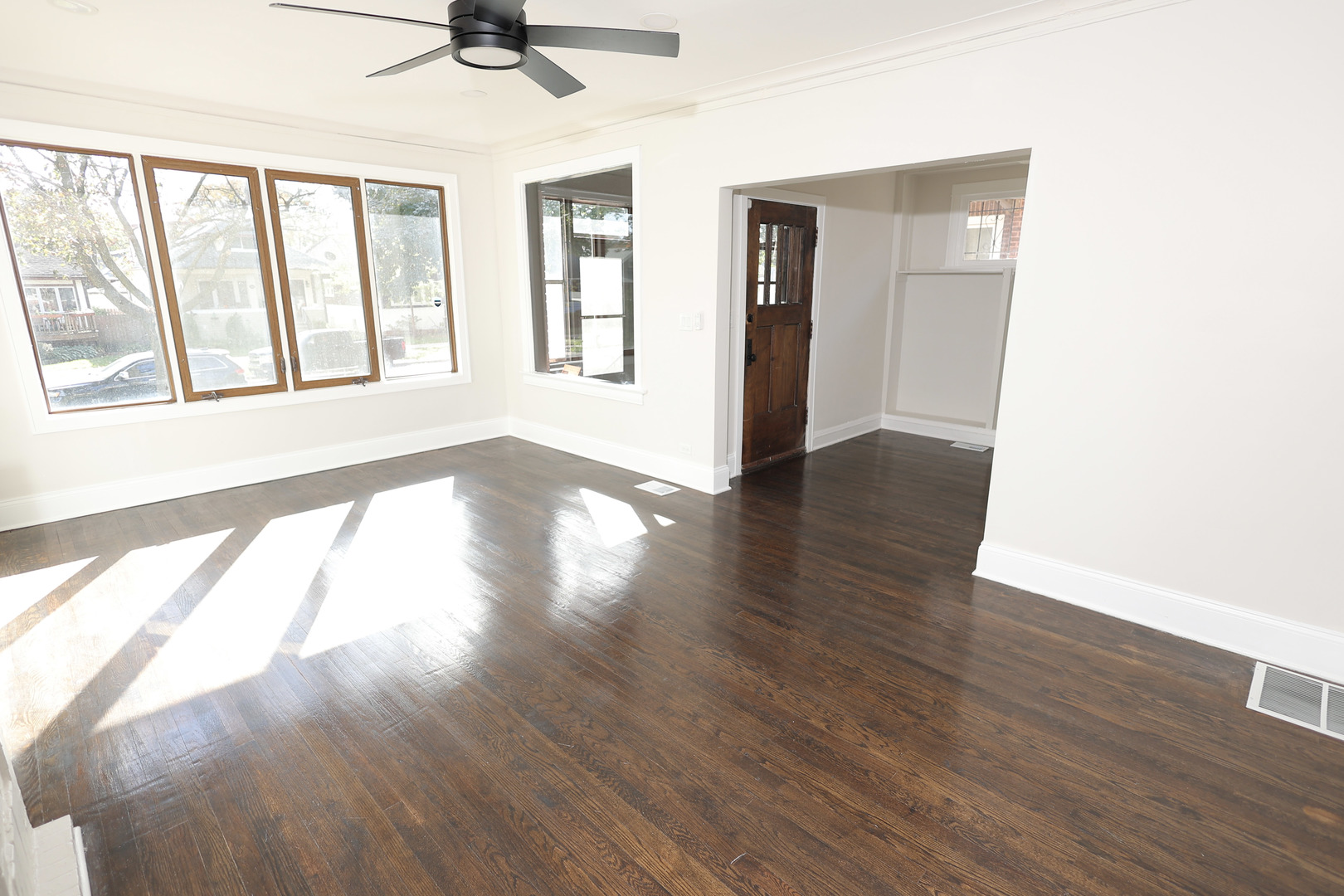 1724 West 105th Street Chicago, IL 60643 - Photo 2 of 34 a view of an empty room with wooden floor and a window