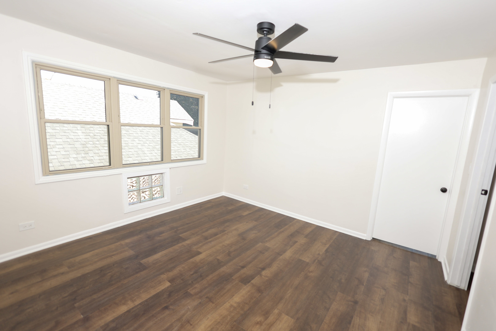 1724 West 105th Street Chicago, IL 60643 - Photo 21 of 34 an empty room with wooden floor fan and windows