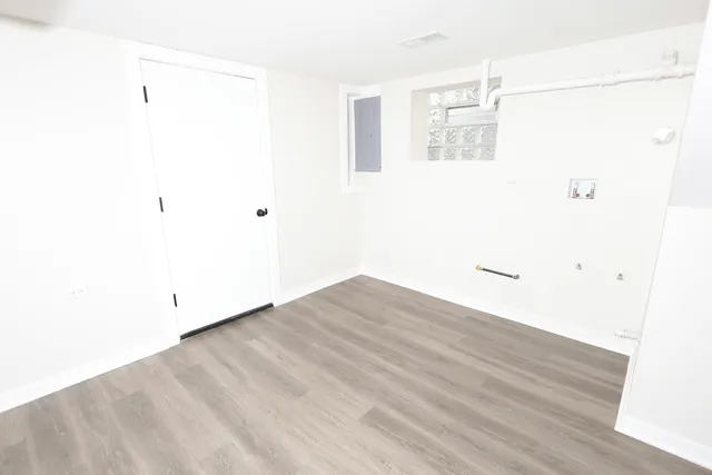 a view of a house with a large window and wooden floor