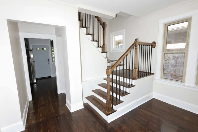 a view of entryway with wooden floor and stairs