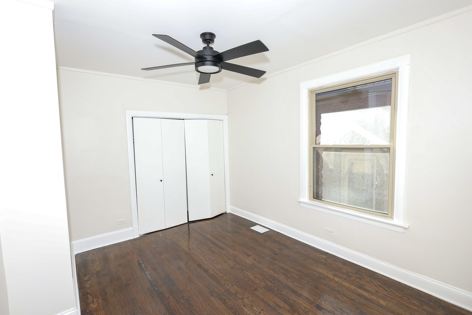 1724 West 105th Street Chicago, IL 60643 - Photo 9 of 34 a view of a big room with wooden floor a ceiling fan and windows