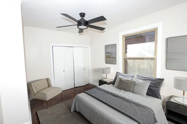 a bedroom with a bed and a window