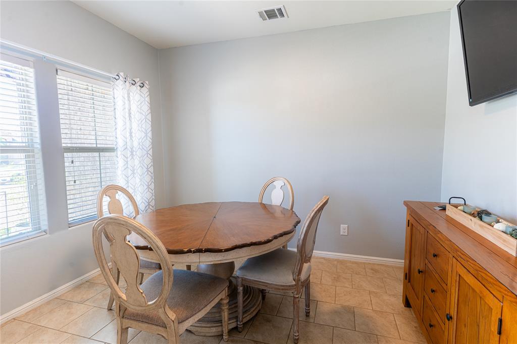 753 Rutherford Drive Crowley, TX 76036 - Photo 4 of 26 Dining area featuring tile flooring, neutral wall paint, and multiple windows