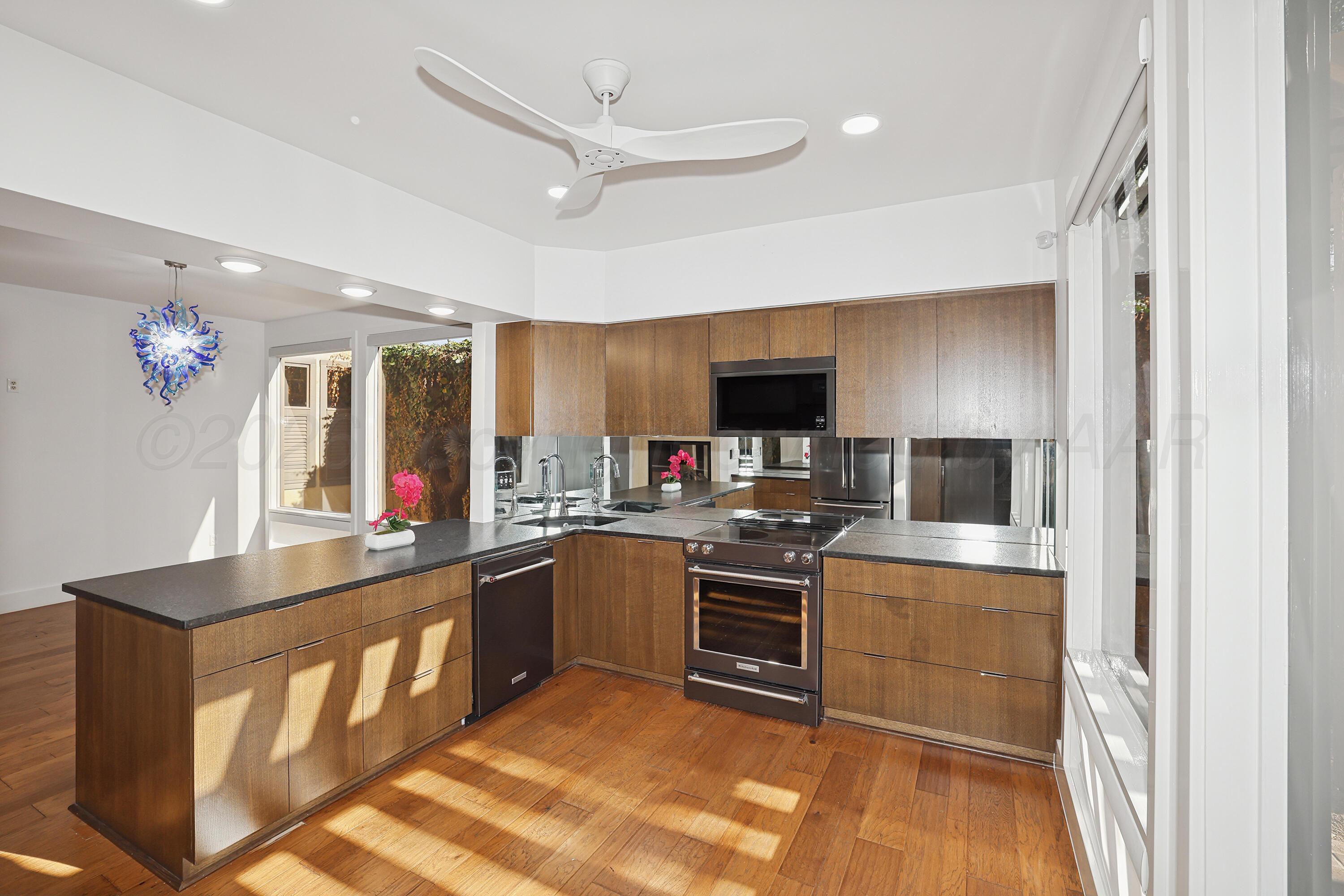 2 Woodstone Street Amarillo, TX 79106 - Photo 12 of 34 a kitchen with stainless steel appliances kitchen island granite countertop a sink and a stove