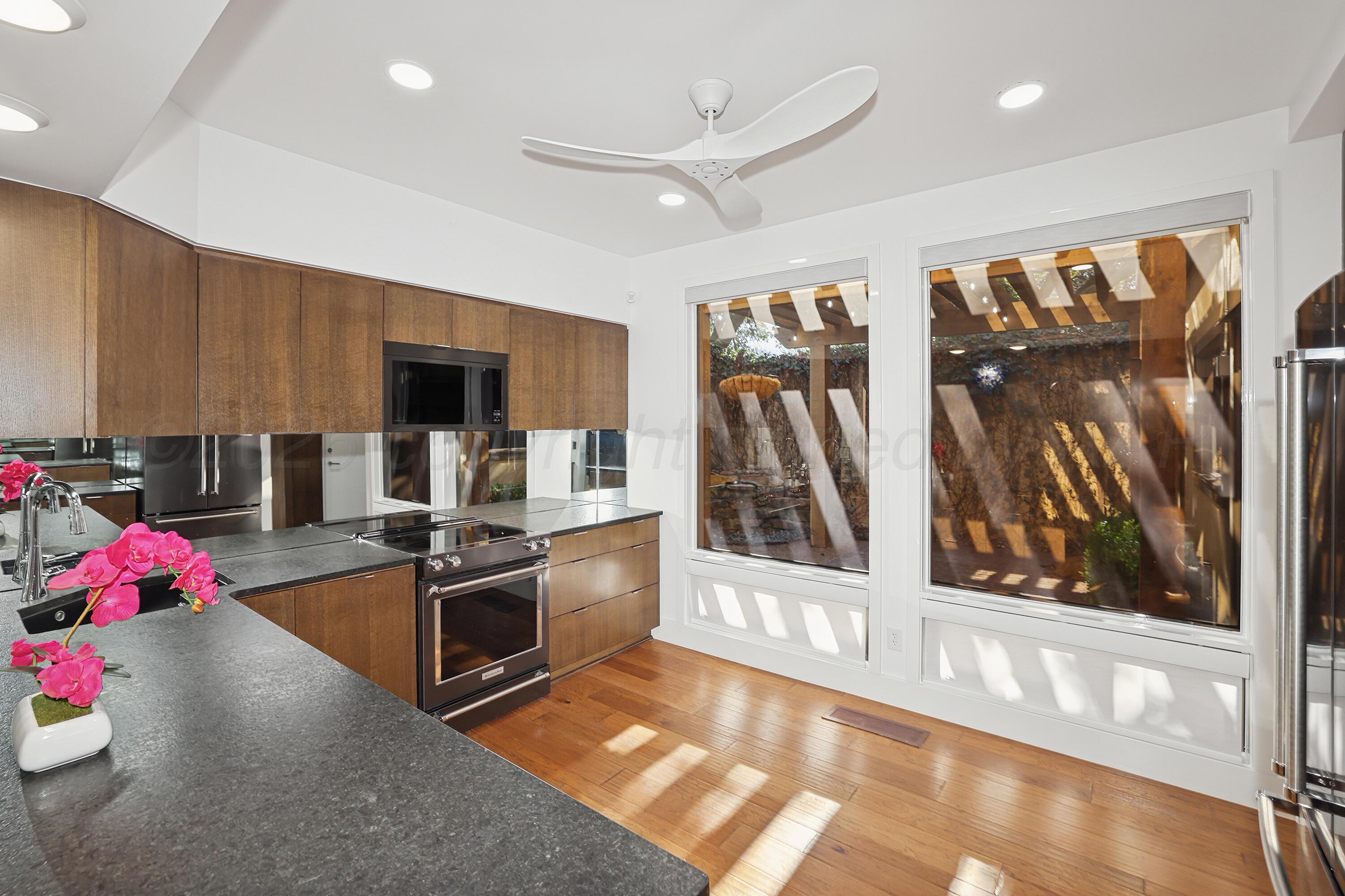 2 Woodstone Street Amarillo, TX 79106 - Photo 13 of 34 a kitchen with granite countertop a stove and cabinets