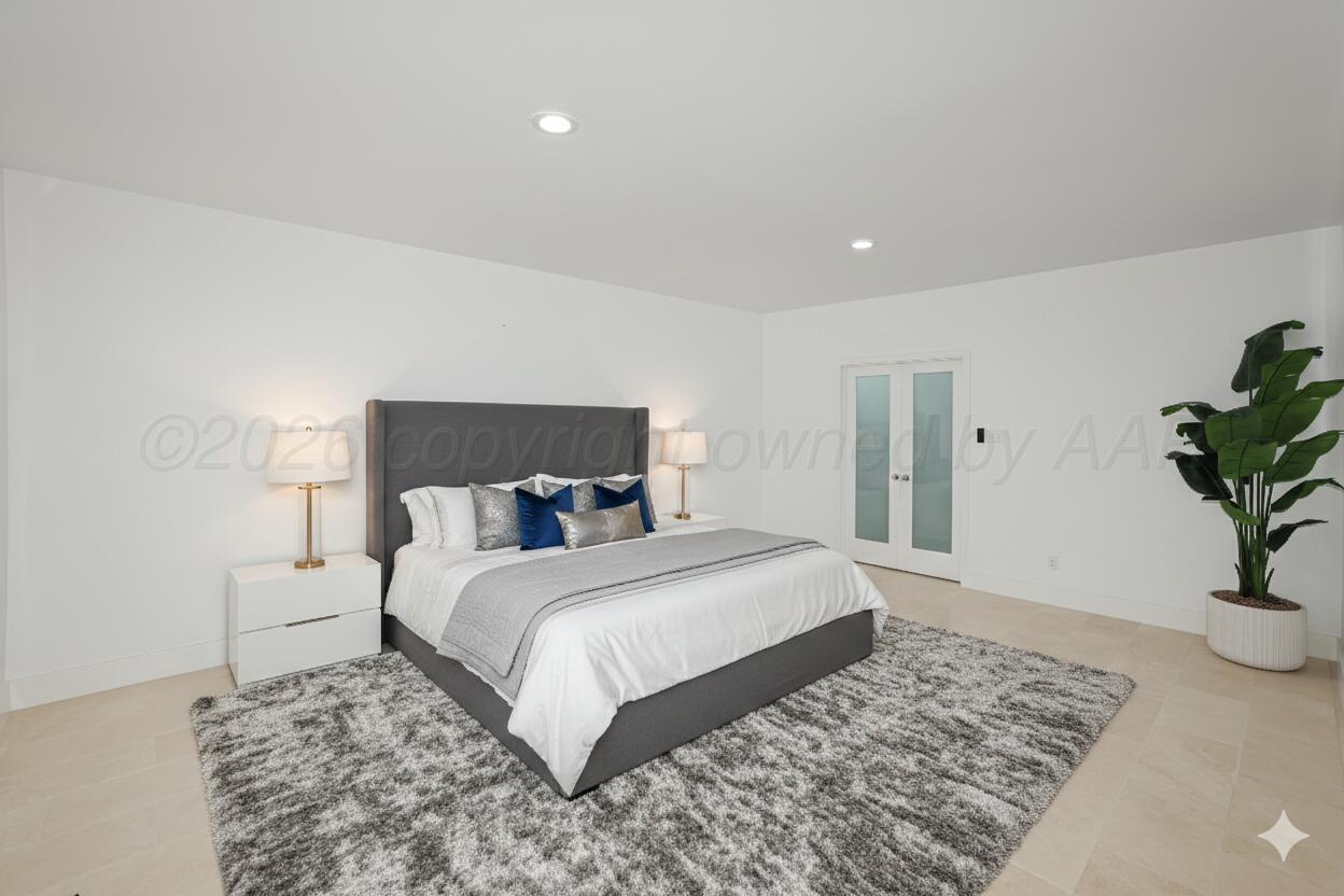 2 Woodstone Street Amarillo, TX 79106 - Photo 14 of 34 a bedroom with a large bed and a potted plant